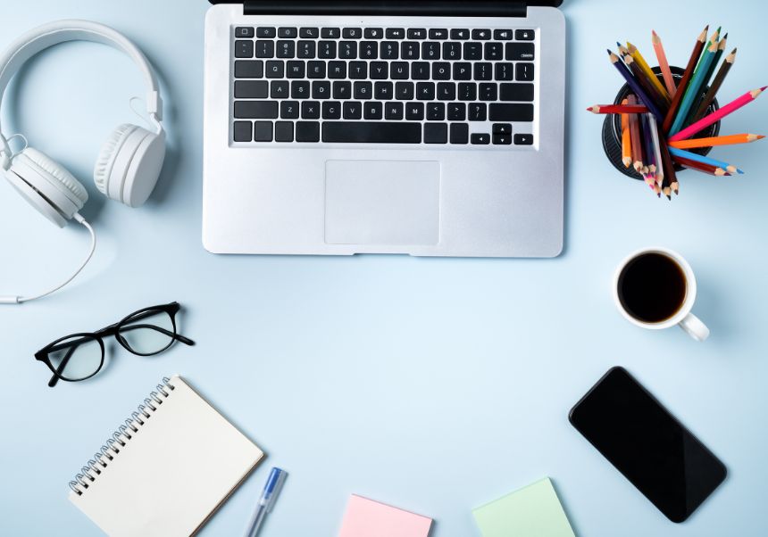 Table with laptop, headphones and mobile